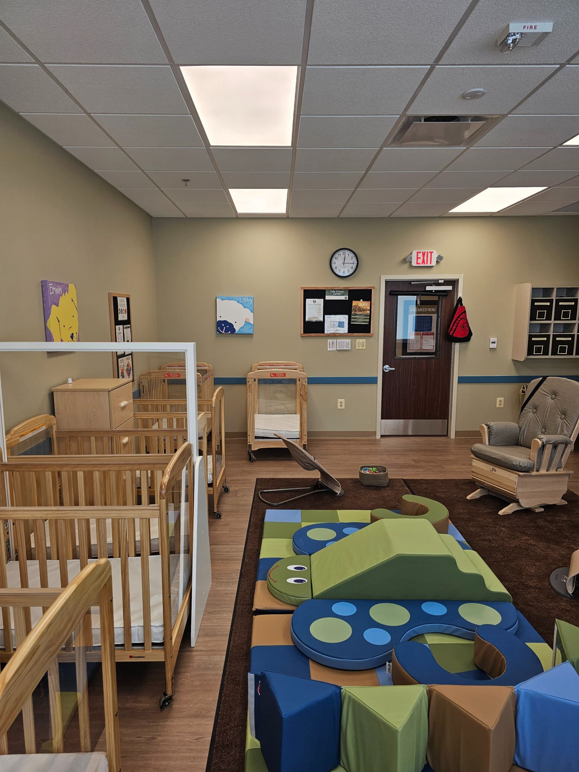 infant room with crib and chair