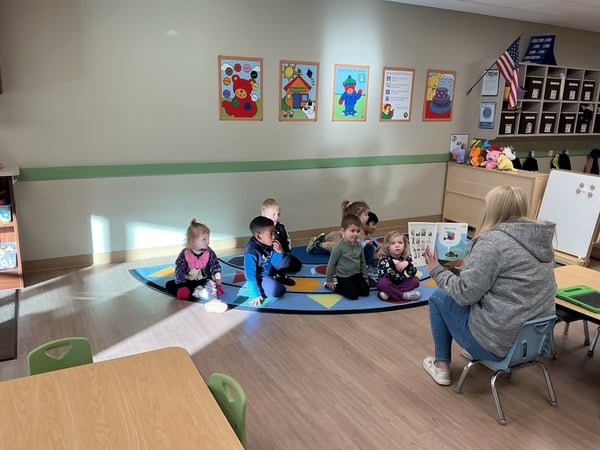 Children participating in circle time at Primrose School, learning and connecting together