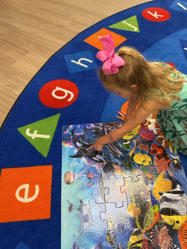 Children working on puzzles to develop fine motor skills and problem-solving abilities