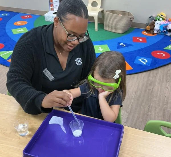woman and girl performing science experiment