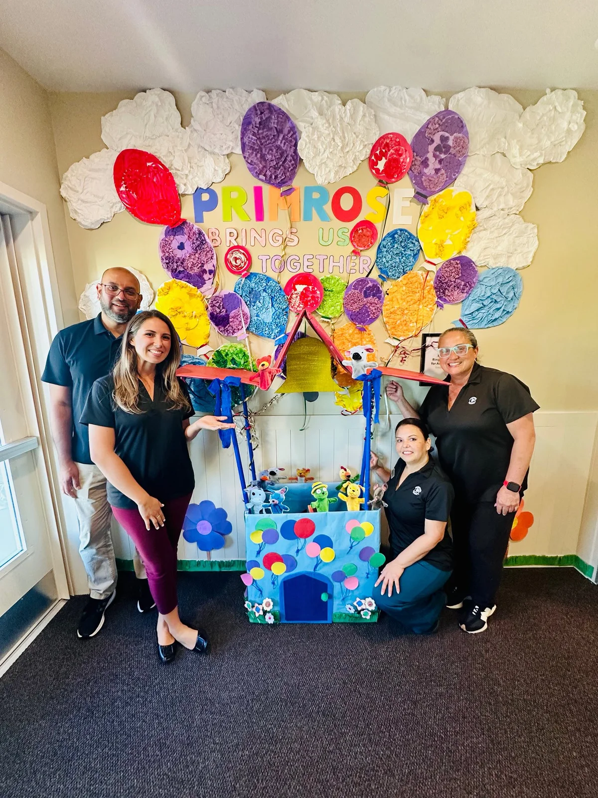 man and three women in front of a hot air balloon art project