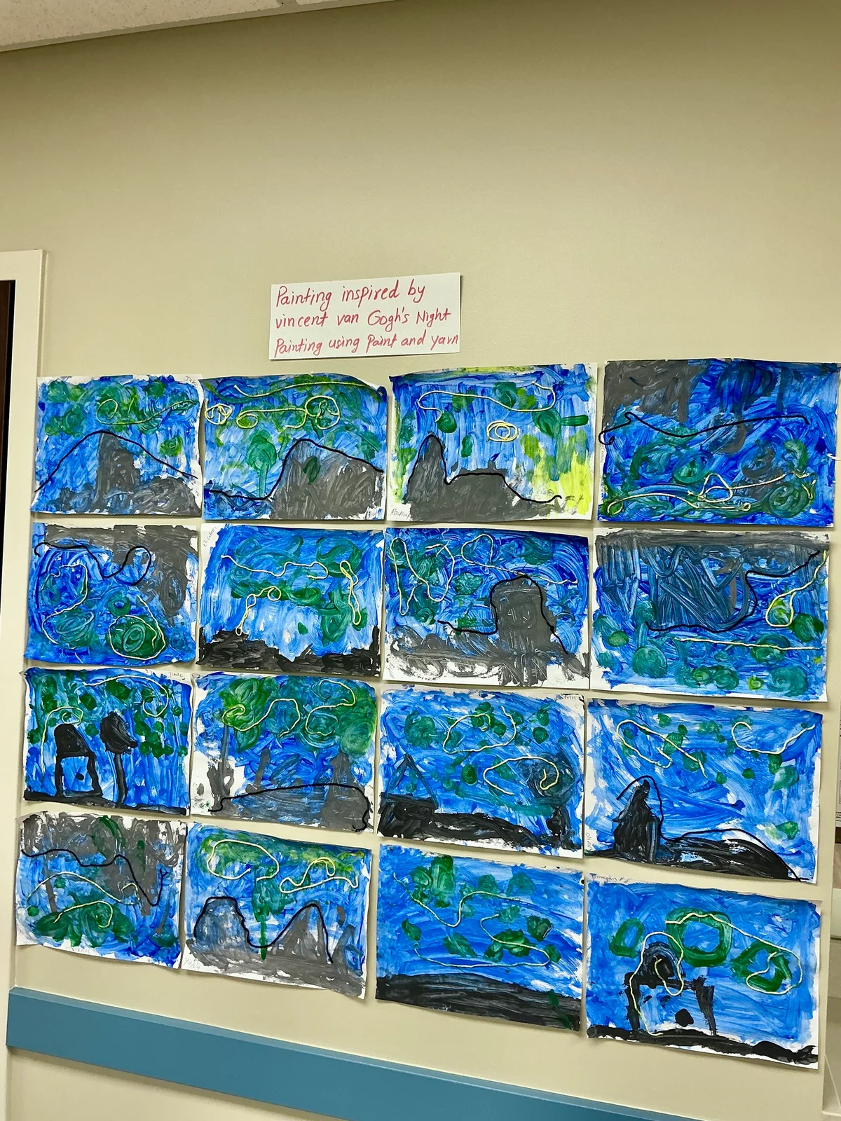wall of multiple paintings made by children