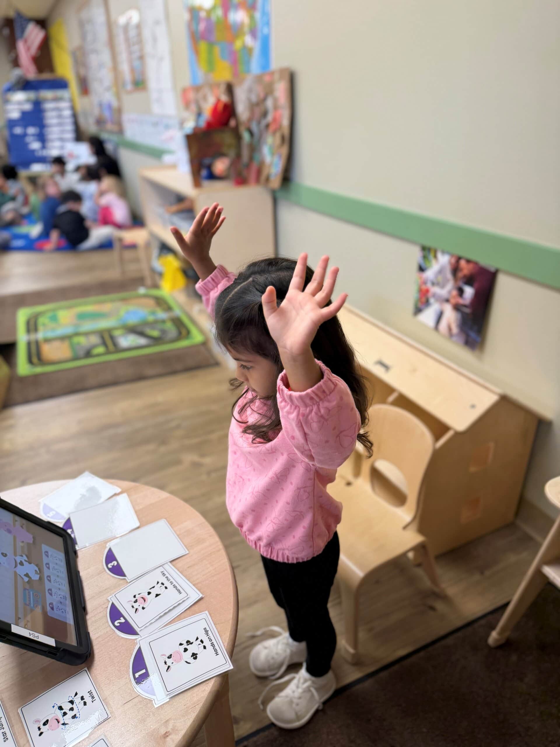 Preschool student engaging with the interactive digital and physical components of the proprietary Balanced Learning App in the Venture classroom.