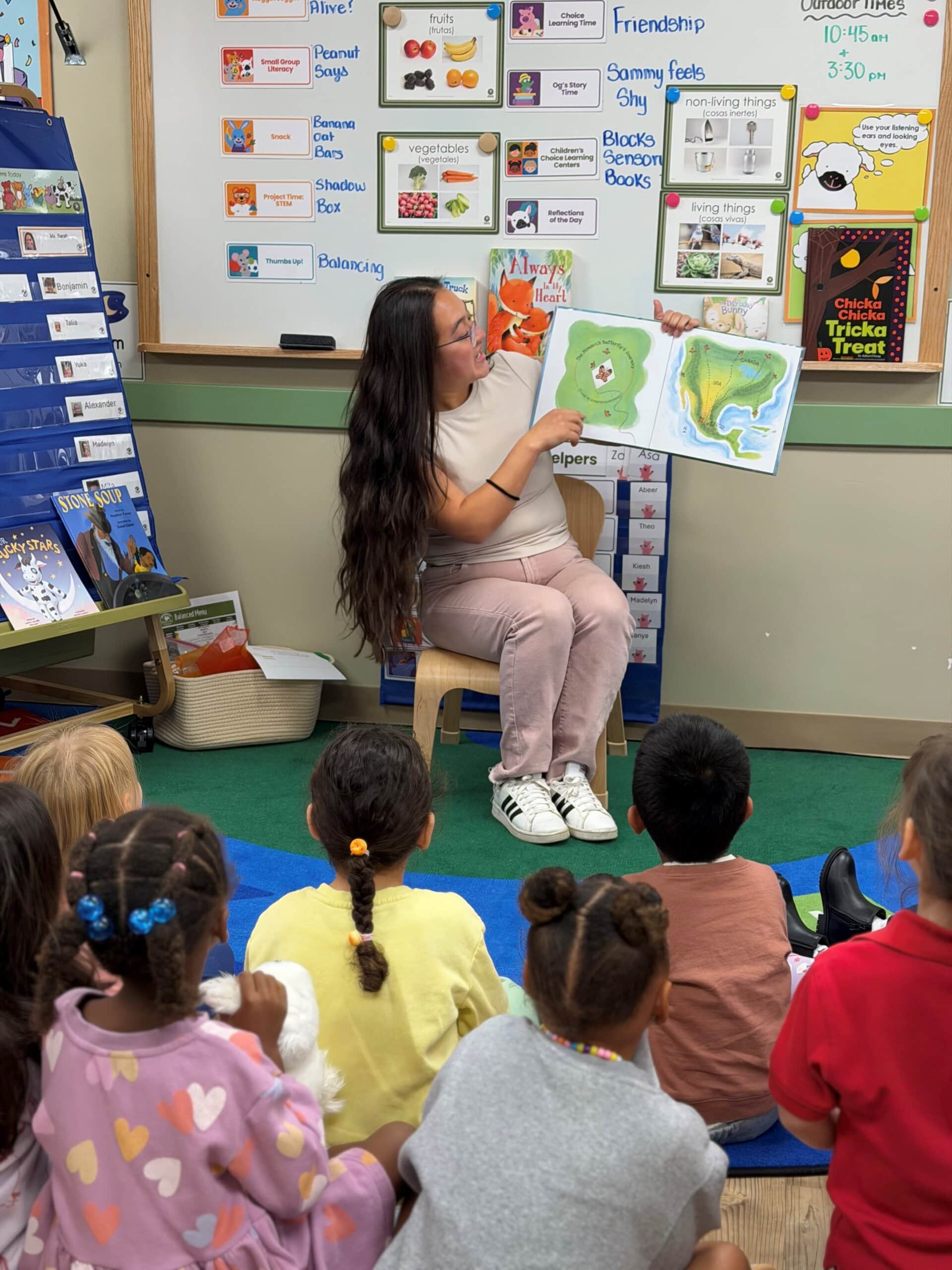 Preschool student exploring Hispanic and Latin American Heritage Month books and cultural activities with a guest reader in the classroom.