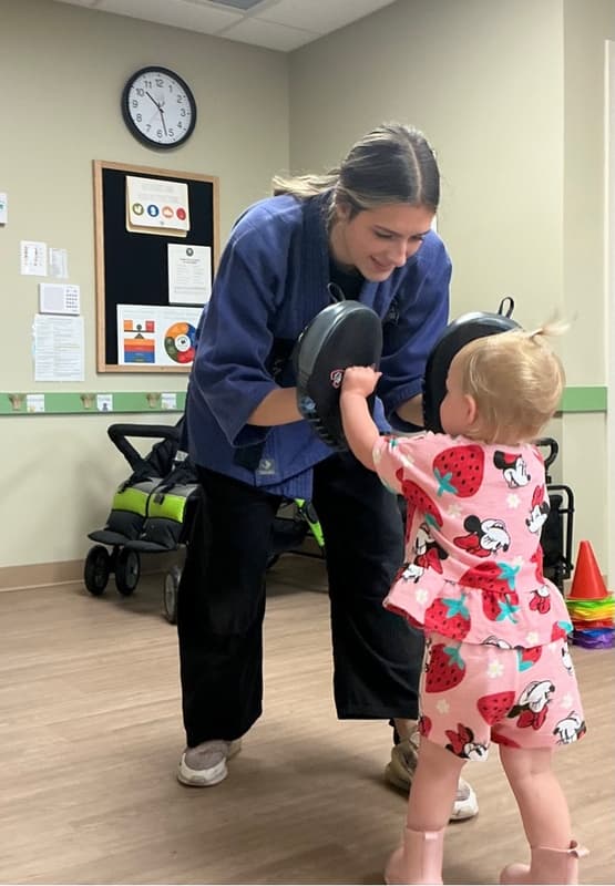 Empire Dojo instructor leading a confidence-building enrichment activity with a student at Primrose School of Forest Hill