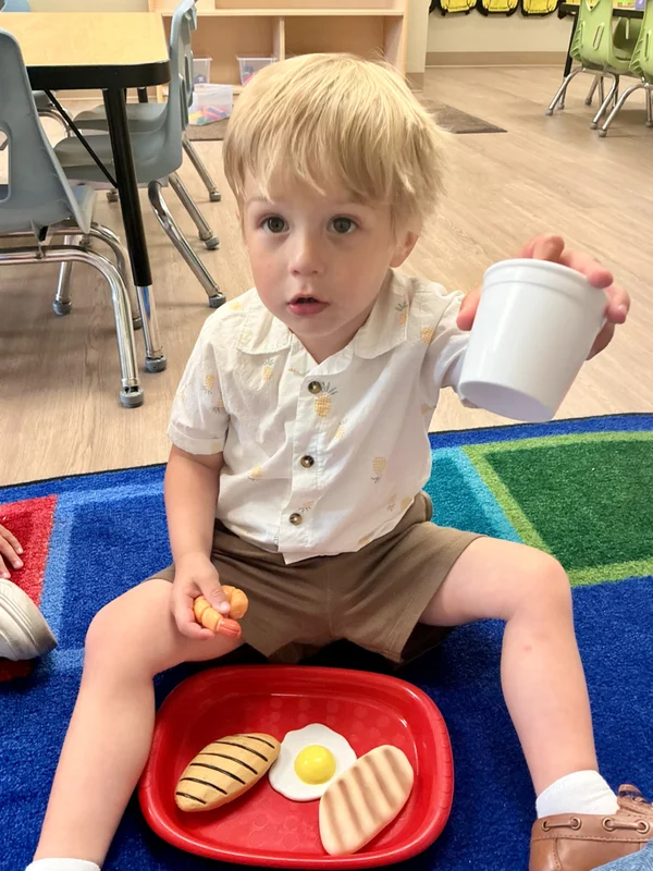Preschool child learning healthy eating habits while enjoying a balanced meal at Primrose School of Forest Hill
