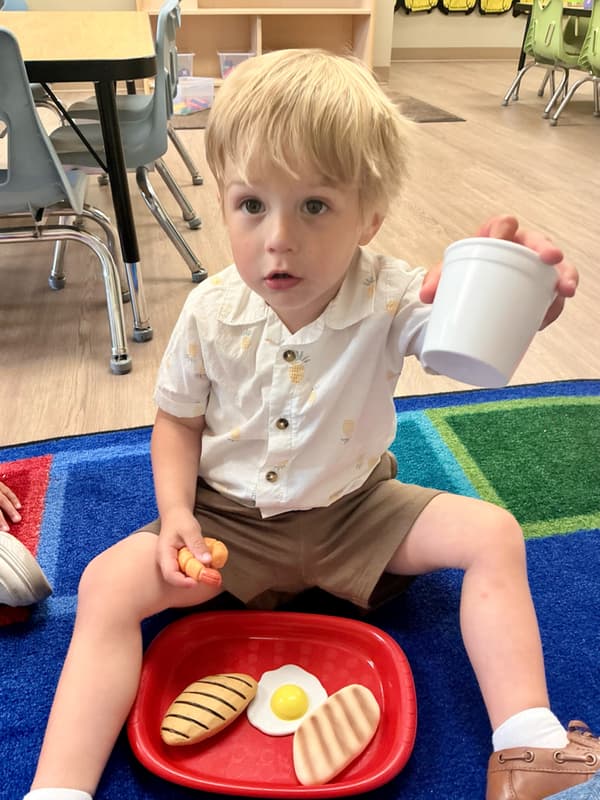 Preschool child learning healthy eating habits while enjoying a balanced meal at Primrose School of Forest Hill