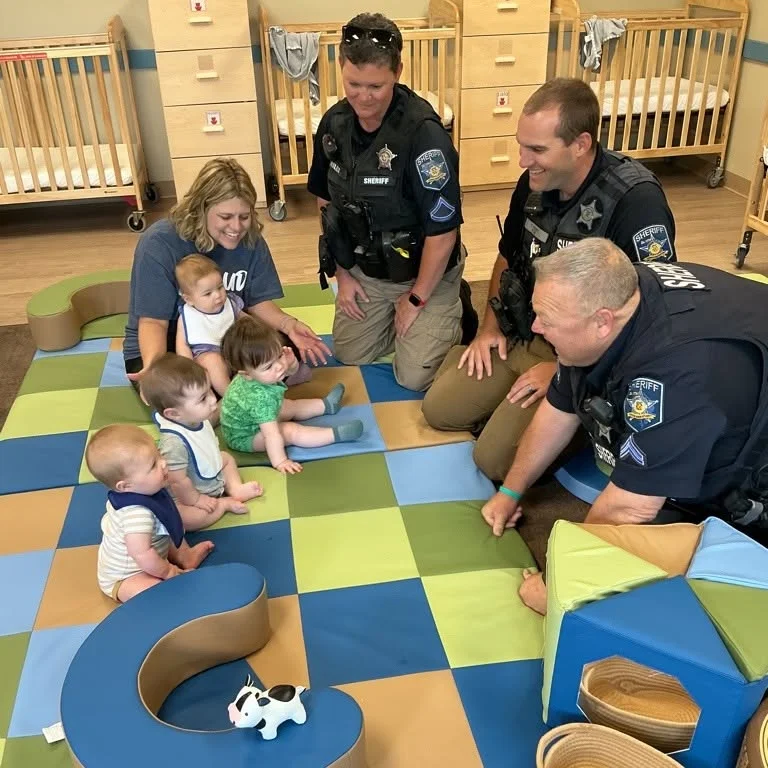Harford County Sheriff's Office representative speaking with preschool children about community safety and helping others.community helpers preschool, Harford County Sheriff's Office, Forest Hill daycare, preschool safety education, early childhood learning, police officer visit school, childcare Harford County, Primrose School Forest Hill and visiting infant room