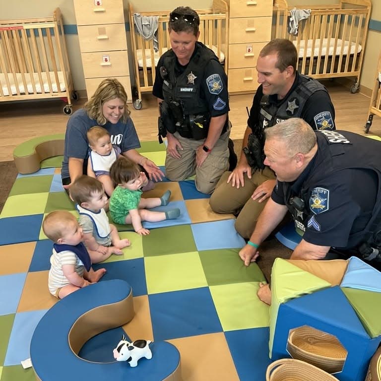 Harford County Sheriff's Office representative speaking with preschool children about community safety and helping others.community helpers preschool, Harford County Sheriff's Office, Forest Hill daycare, preschool safety education, early childhood learning, police officer visit school, childcare Harford County, Primrose School Forest Hill and visiting infant room