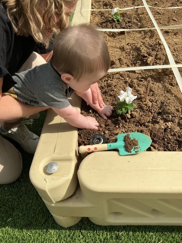 Infant Earth Day planting activity at Primrose School of Forest Hill little hands exploring nature and sustainability