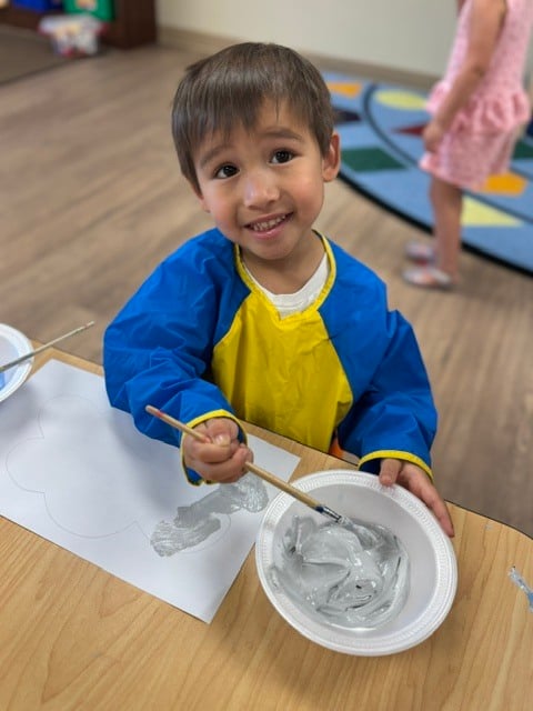 Child painting a cloud