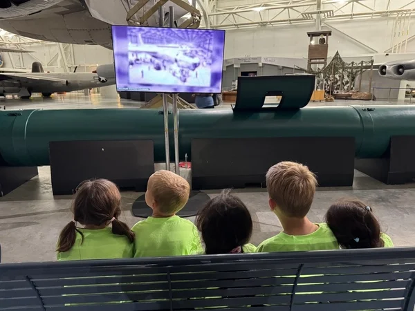 children watching a plane demonstration