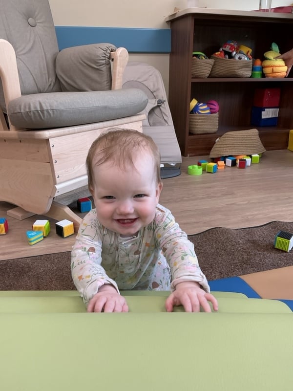 Primrose School of Clintonville Infant student working on physical development skills in the classroom