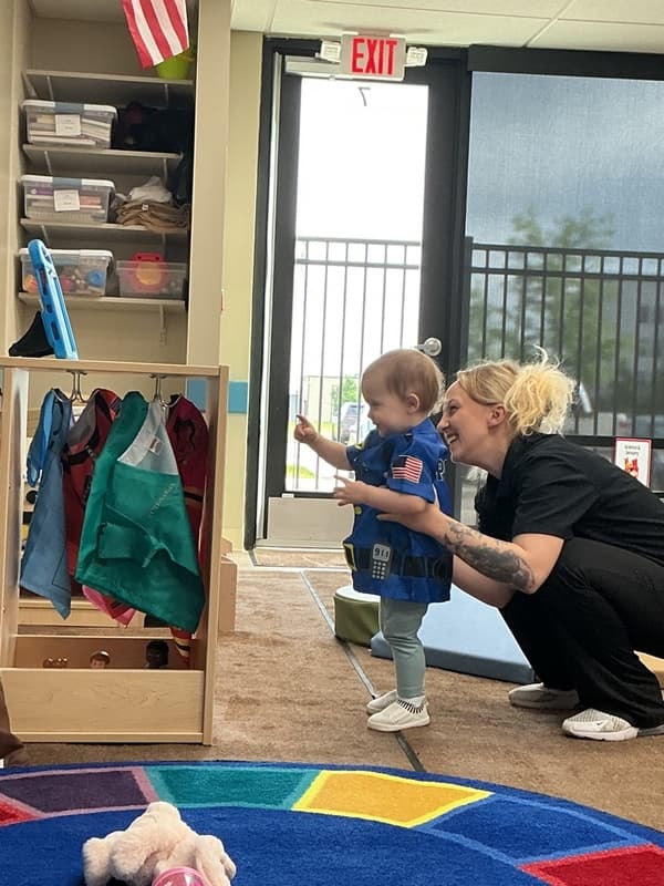 Primrose School of Clintonville Toddler student using dress up with their teacher