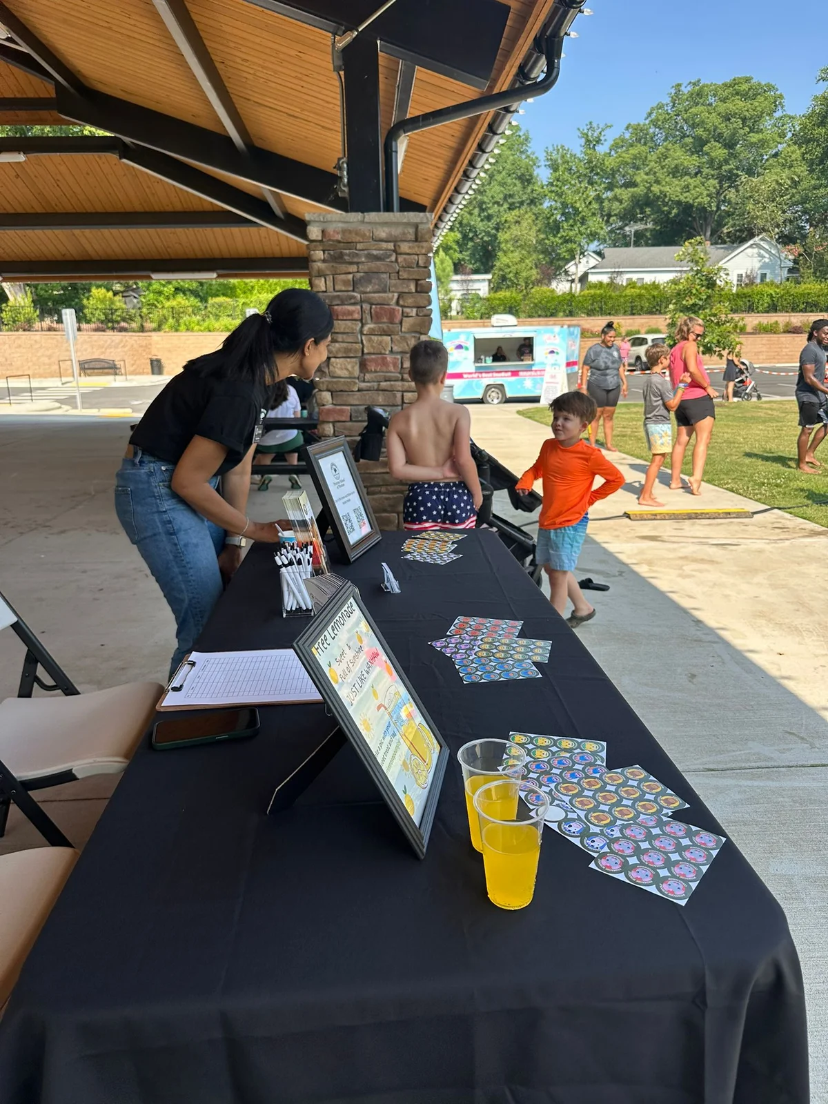 franchise owner talking with kids at water day