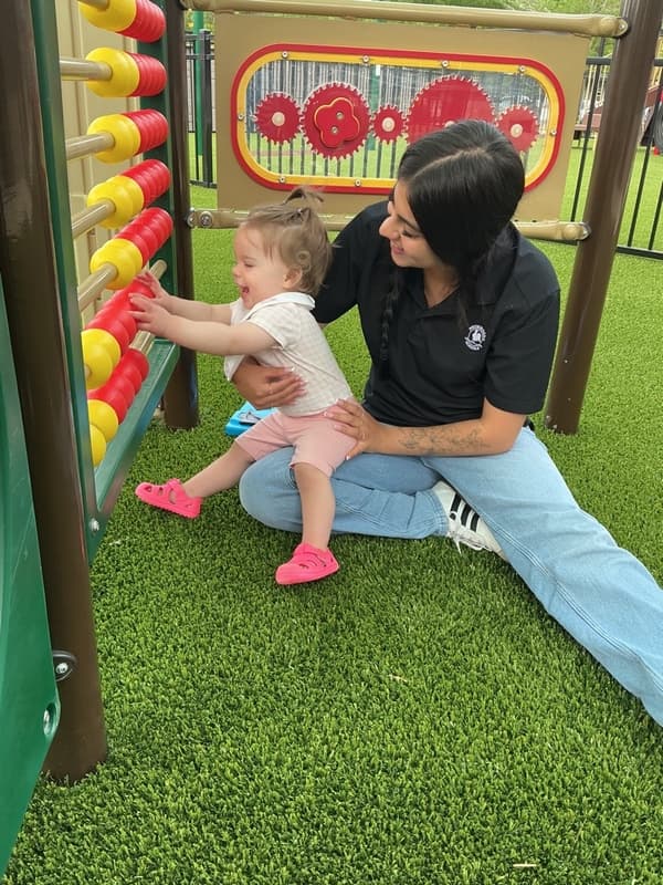 Primrose School of Clintonville Toddler student on the playground with their teacher