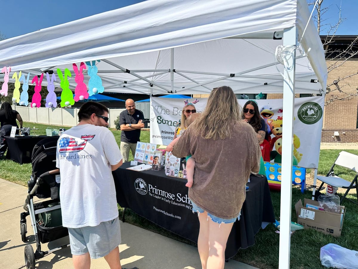 Waxhaw family interacting with Primrose Preschool at Easter event