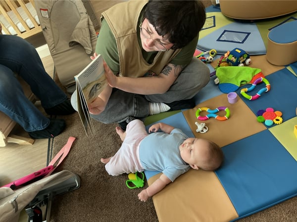 Primrose School of Clintonville Infant student engaging in story time with her Teacher