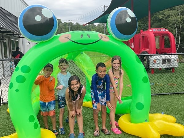 Primrose school of waxhaw students having fun in the sprinklers