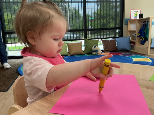 Primrose School of Clintonville Toddler student using crayons