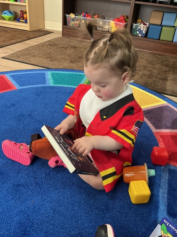 Primrose School of Clintonville Toddler student reading a book