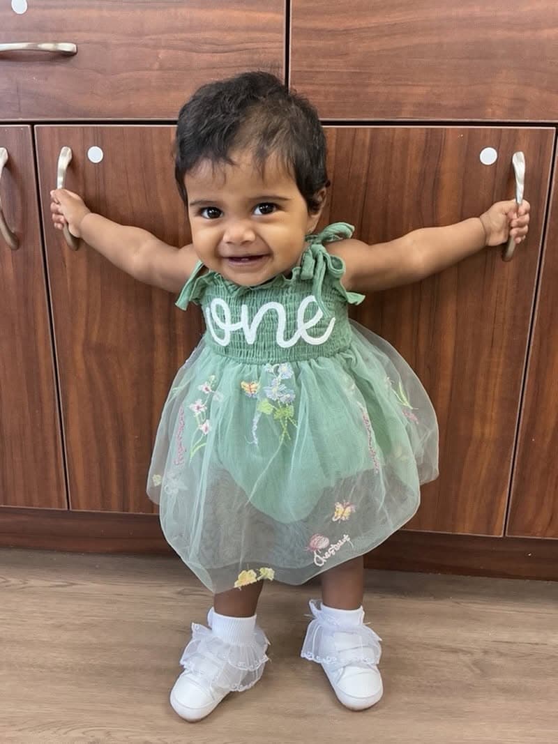 Smiling young toddler celebrating a first birthday milestone while building confidence and independence in the nurturing environment at Primrose School.