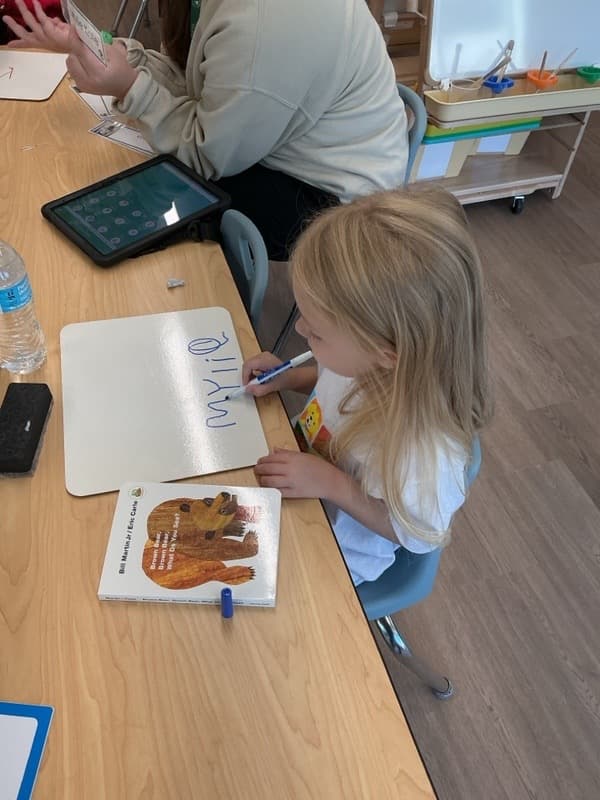 Girl writing her name