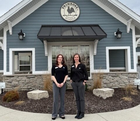 franchise owners lyndi mcvey and megan sifert standing in front of the school