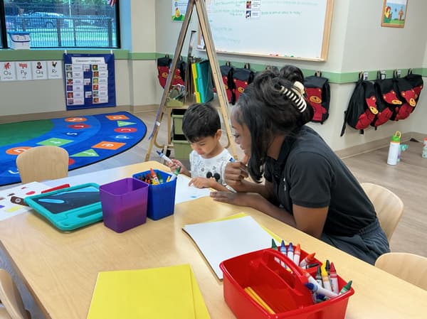teacher and child looking at artwork