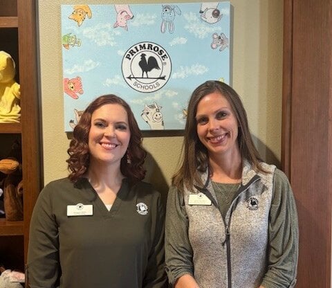 franchise owners lyndi mcvey and megan sifert standing in front of the school
