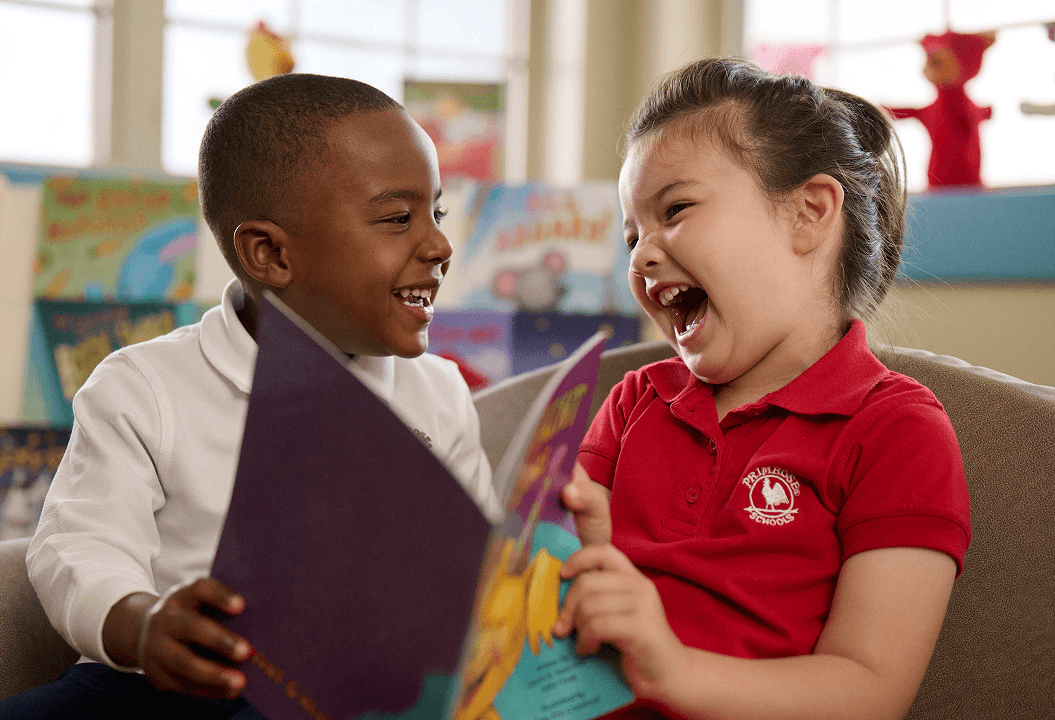 Pre-k students reading a book together