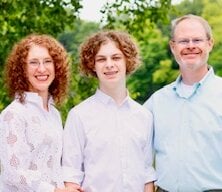 Primrose School of Eden Prairie franchise owners posing with their child
