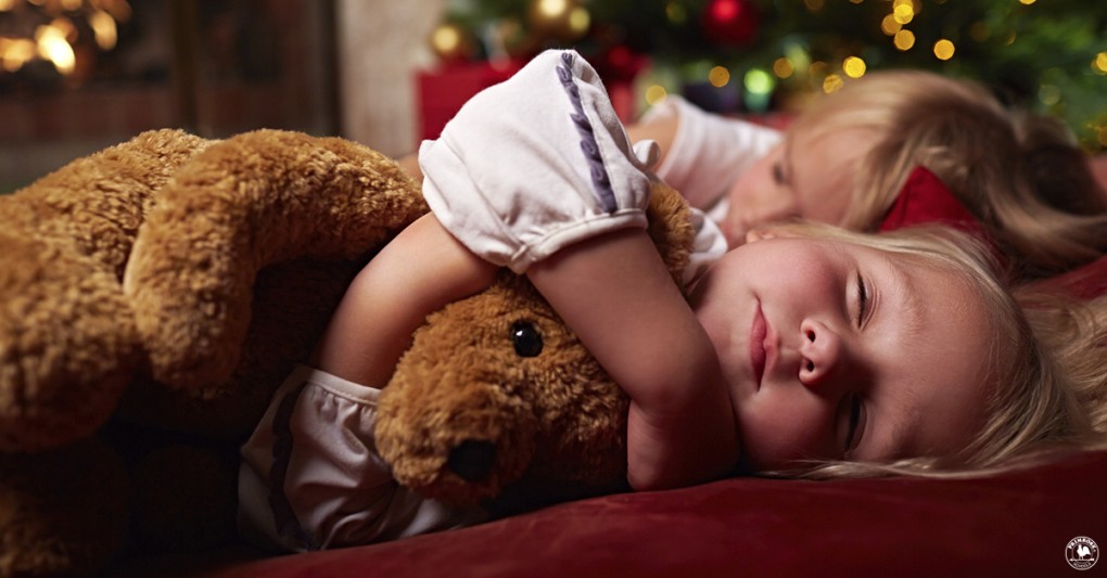 Two young children soundly asleep during the holidays