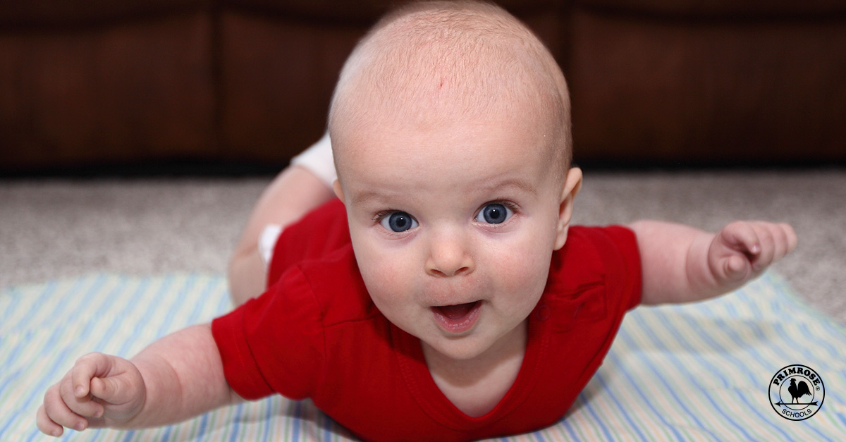Infant lying on floor mat and seems happy