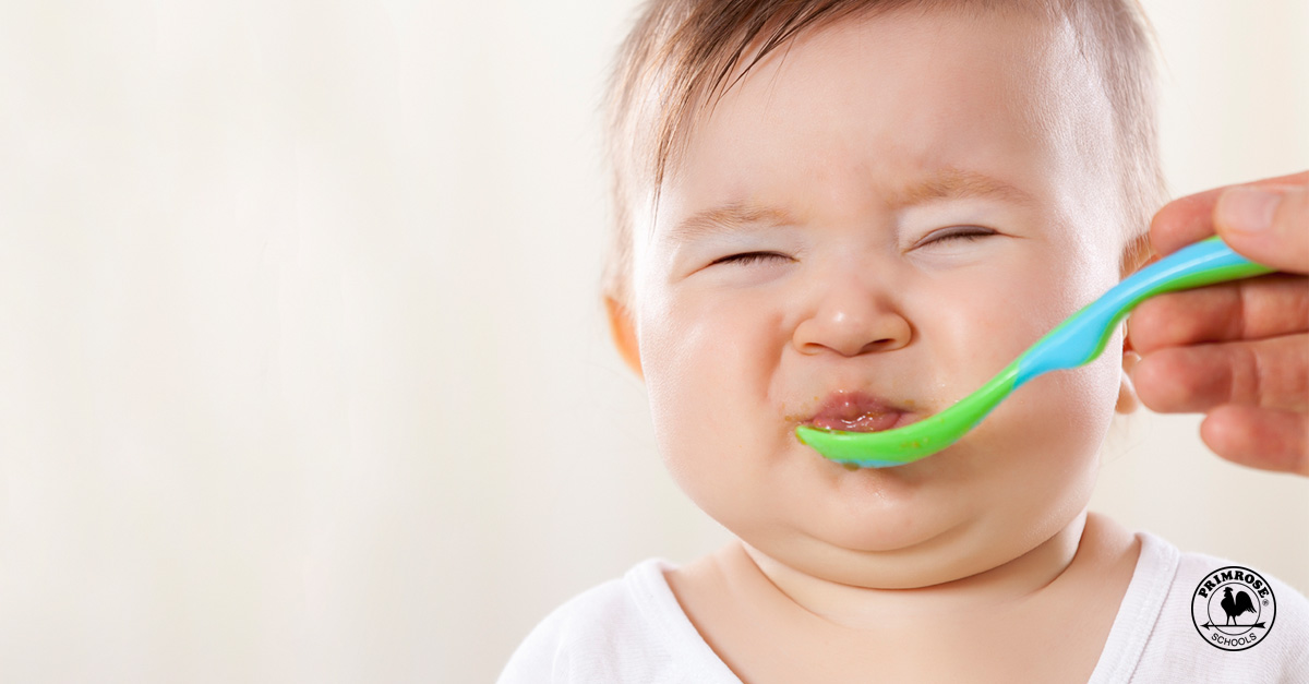 infant making face while eating
