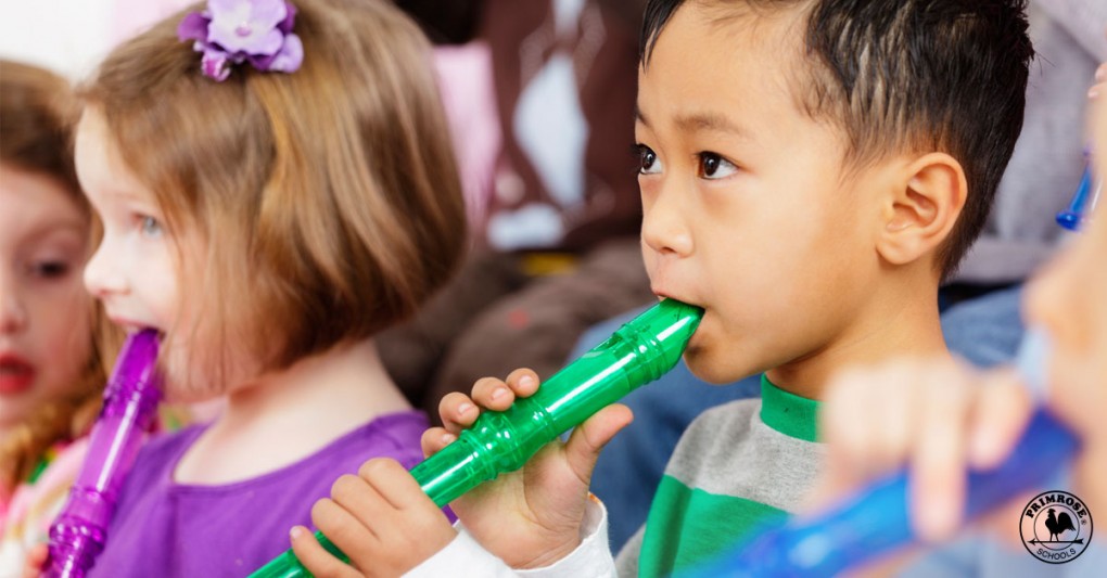 A young boy and girl learn how to play the flute