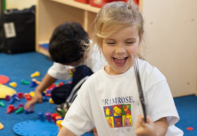 A Primrose student enjoying play time in the classroom