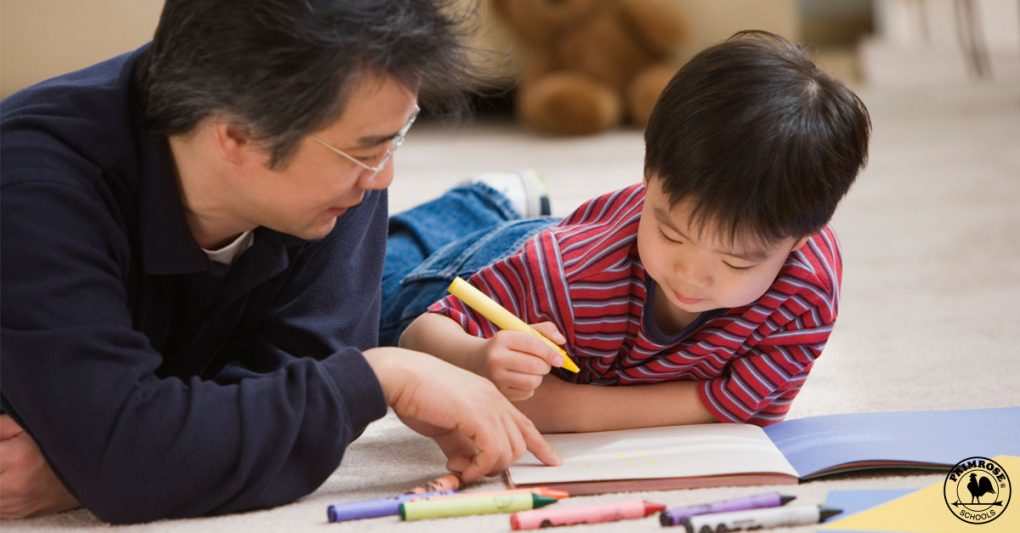 Father helping his son to color