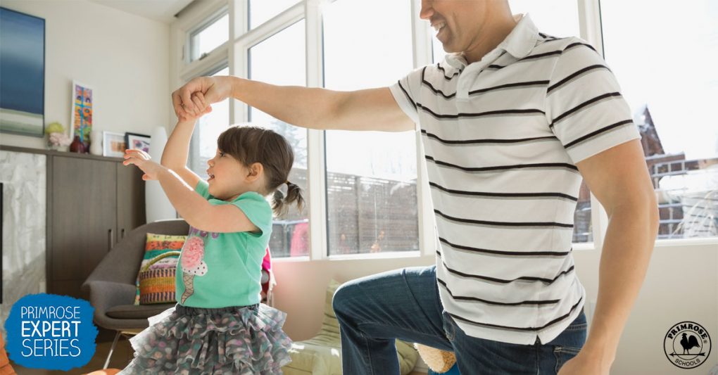 Father twirling his daughter while dancing