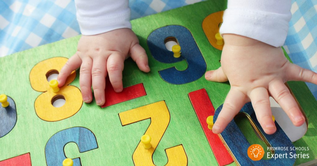 Infant playing with number puzzles