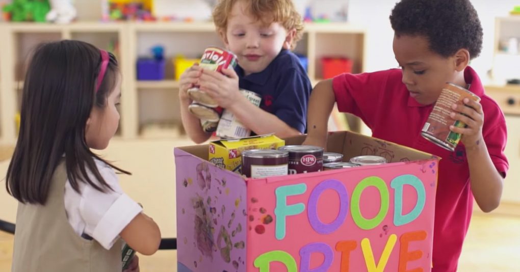 Children placing canned food in a box that reads FOOD DRIVE
