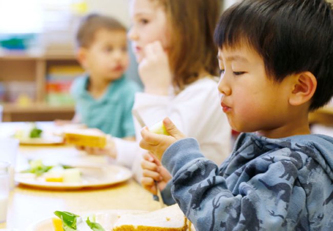 Young children enjoying a healthy meal in the classroom