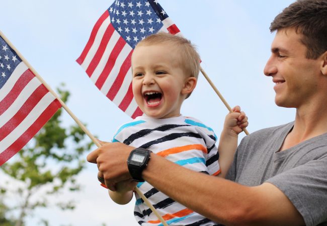 Father and son with American flags