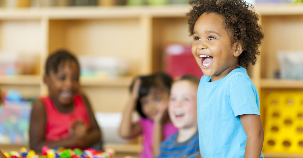 3-5 year old preschool children smile in classroom
