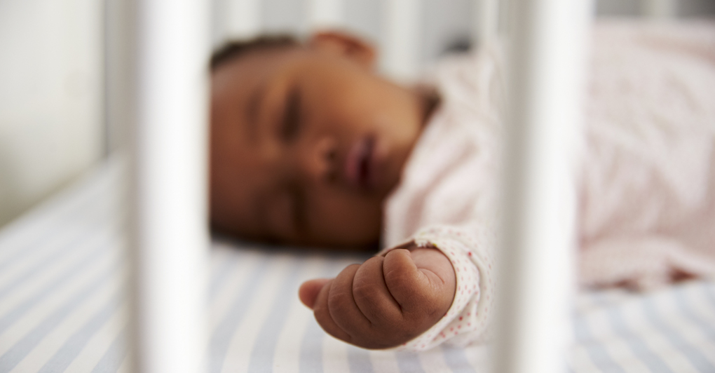 Baby lays in crib sleeping through the night