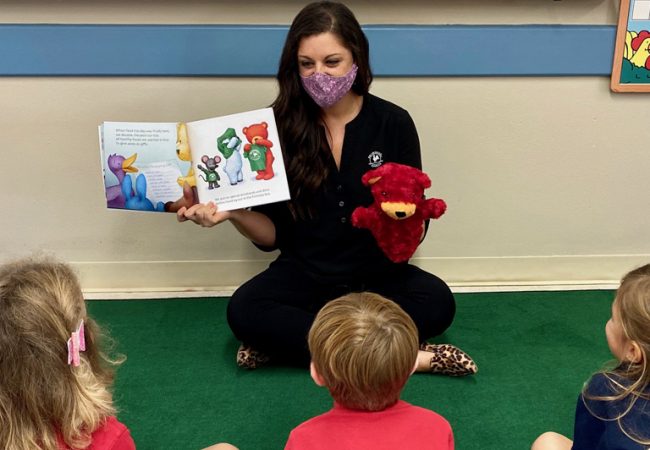 Image of teacher reading a harmony and heart book to the students