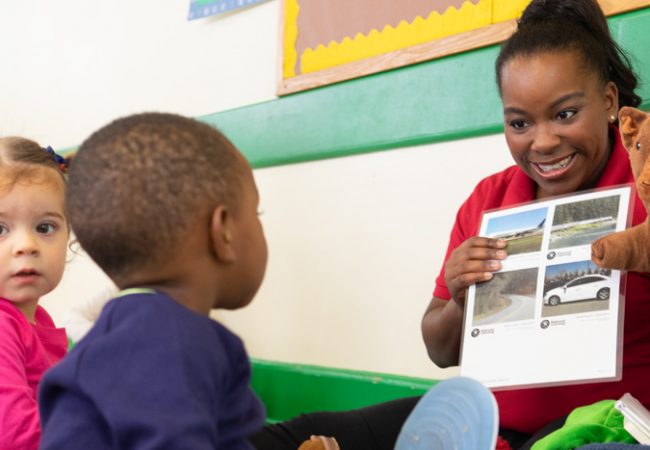 teacher pointing to pictures for toddler