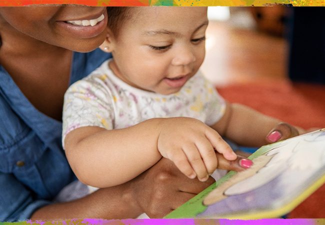 smiling adult reading to a toddler