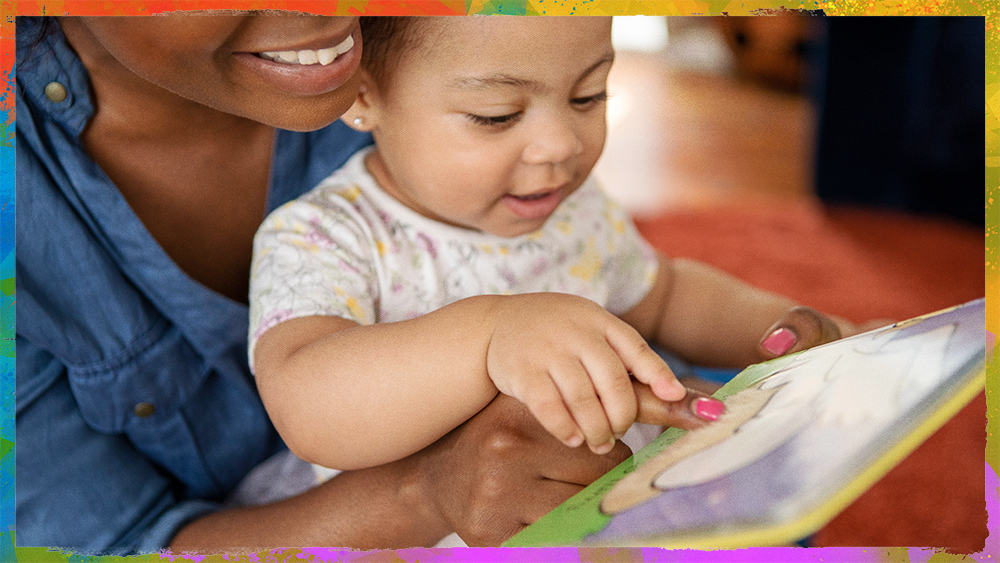 smiling adult reading to a toddler