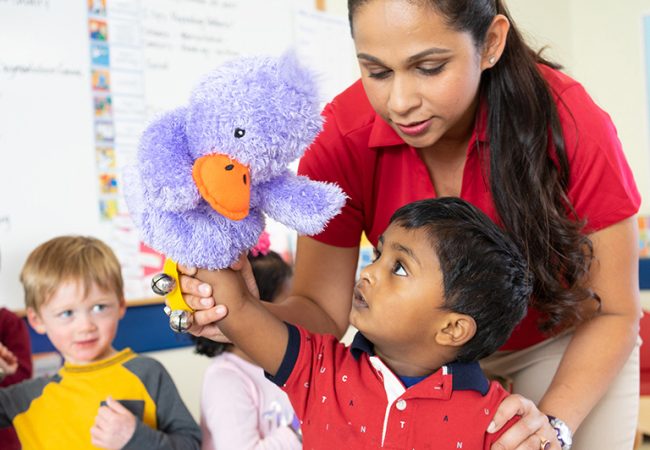 teacher helping student with puppet